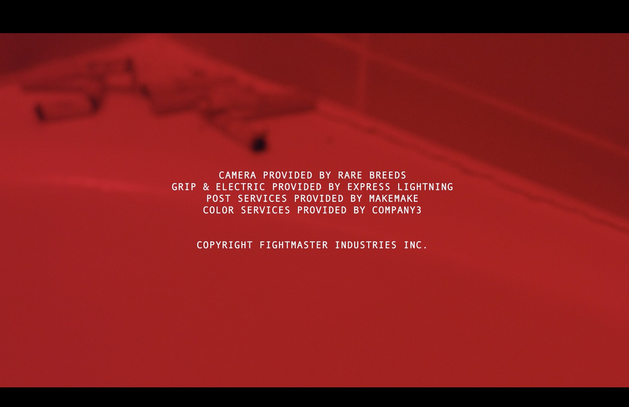 Red background with white text credits various service providers for camera, grip, electric, post services, and color services, and includes a copyright notice.