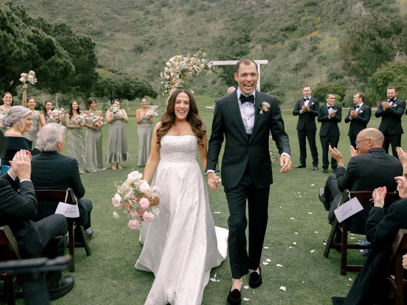 Bride and groom walking down the aisle after their wedding ceremony at the Ranch in Laguna Beach.