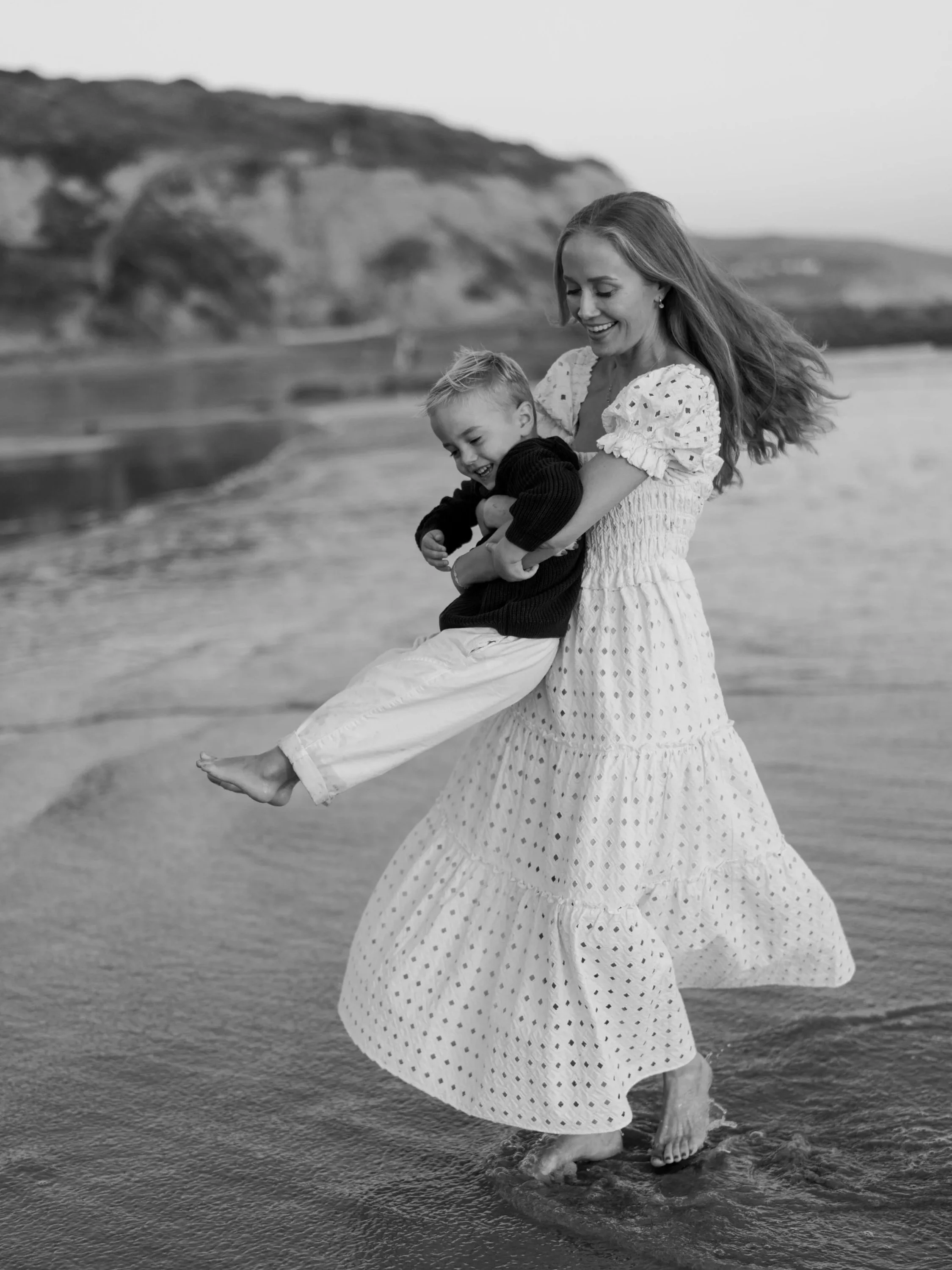 Orange County Family Photographer, Erin Bathurst, takes photos with her son playing on the beach in Crystal Cove.