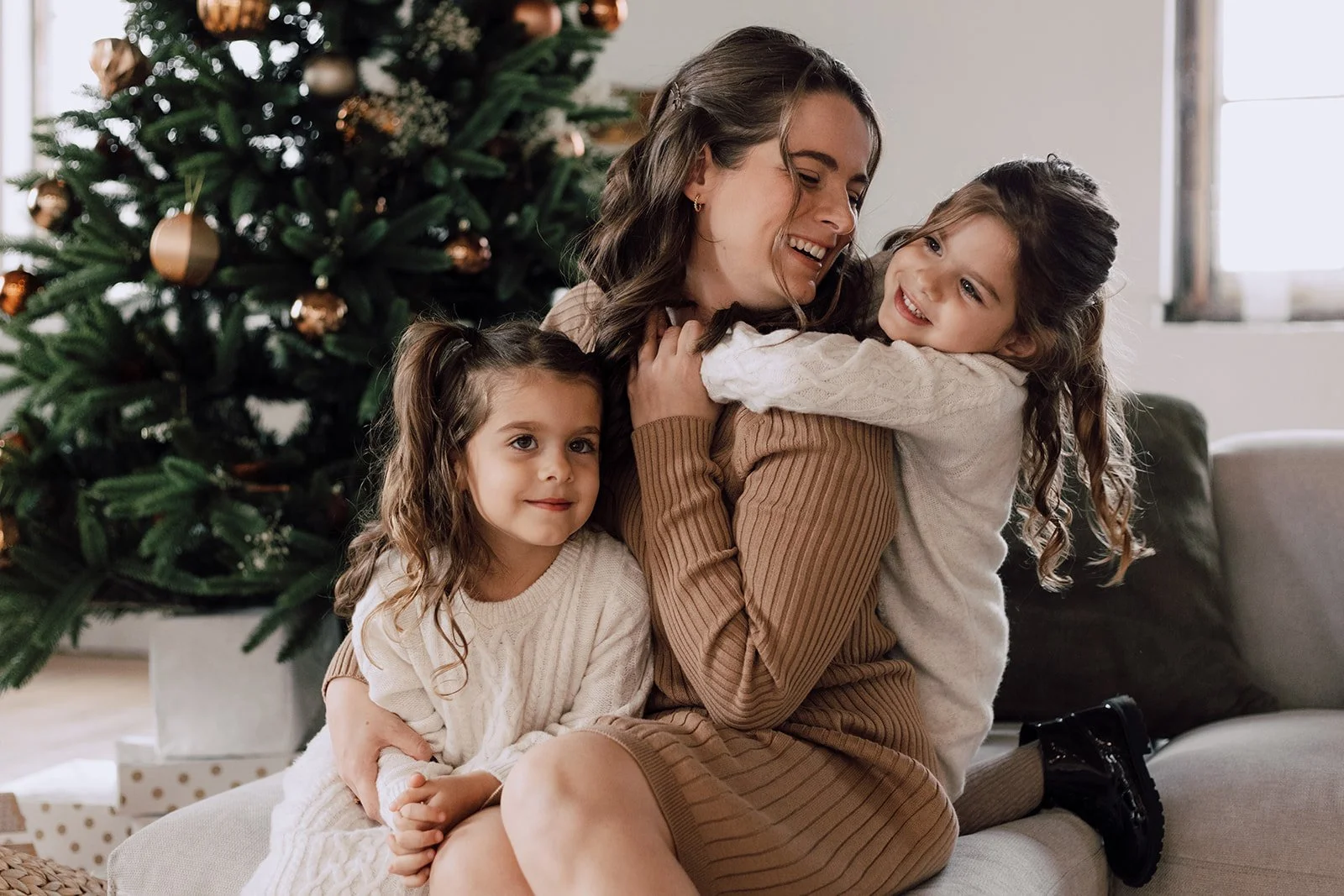 mom and twins in front of chrismas tree at millworks creative in hamilton