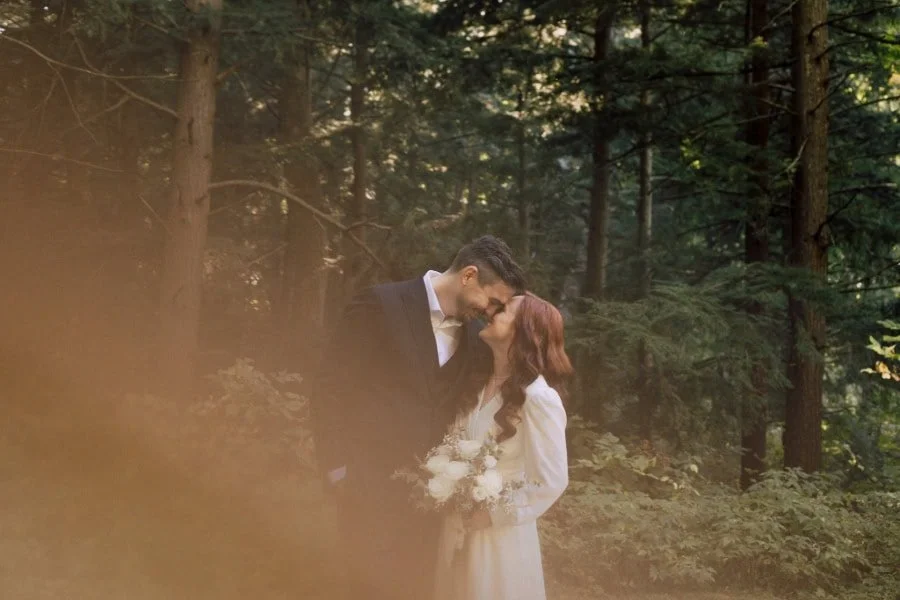 Candid of a bride and groom in a forest after their wedding elopement in Hamilton