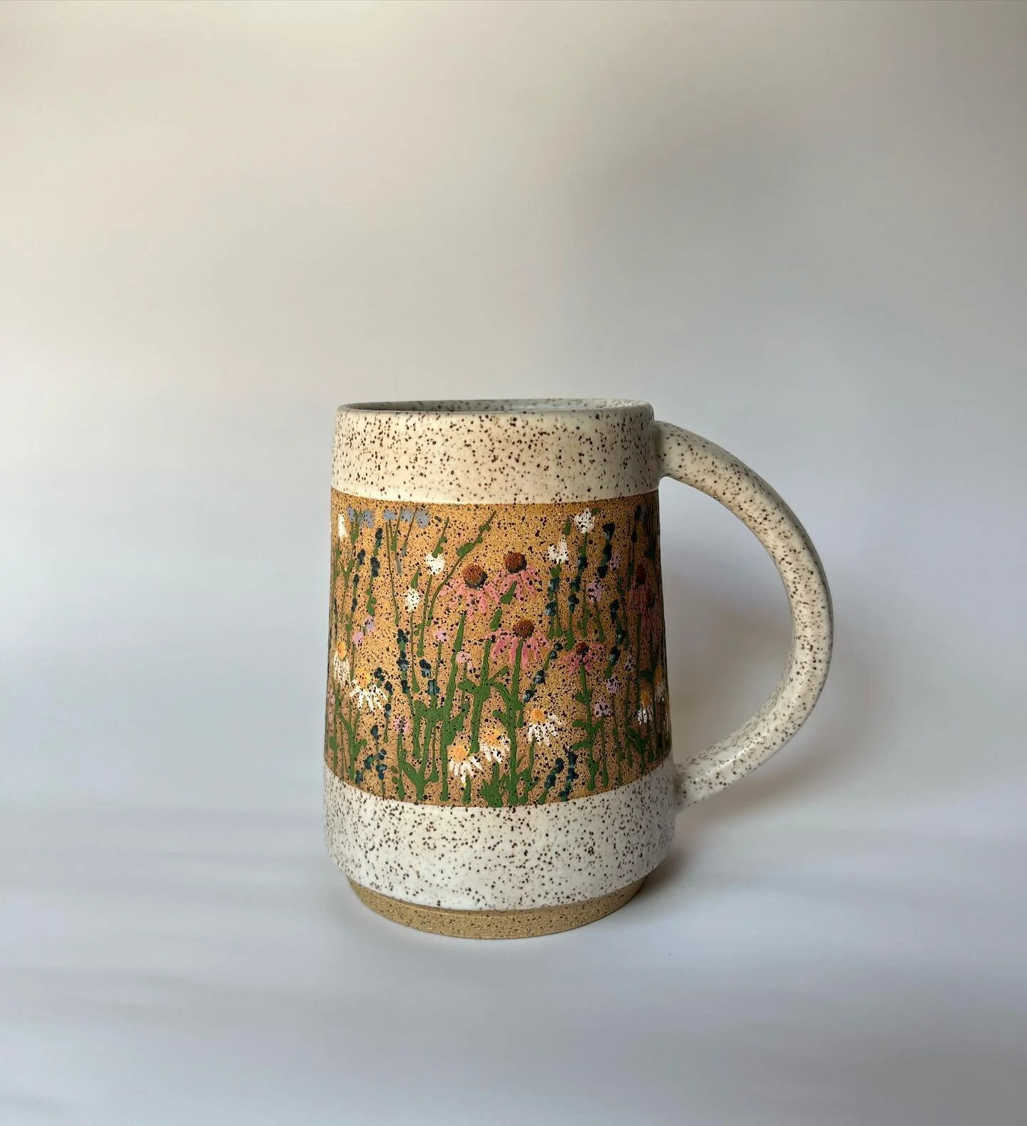 It’s a little early to call, but I think this is my favorite mug of 2023. This was a test piece, and (luckily for me) during the glaze fire, it got a chunky fleck from the thermocouple melted into the inside bottom. It looks like someone ashed