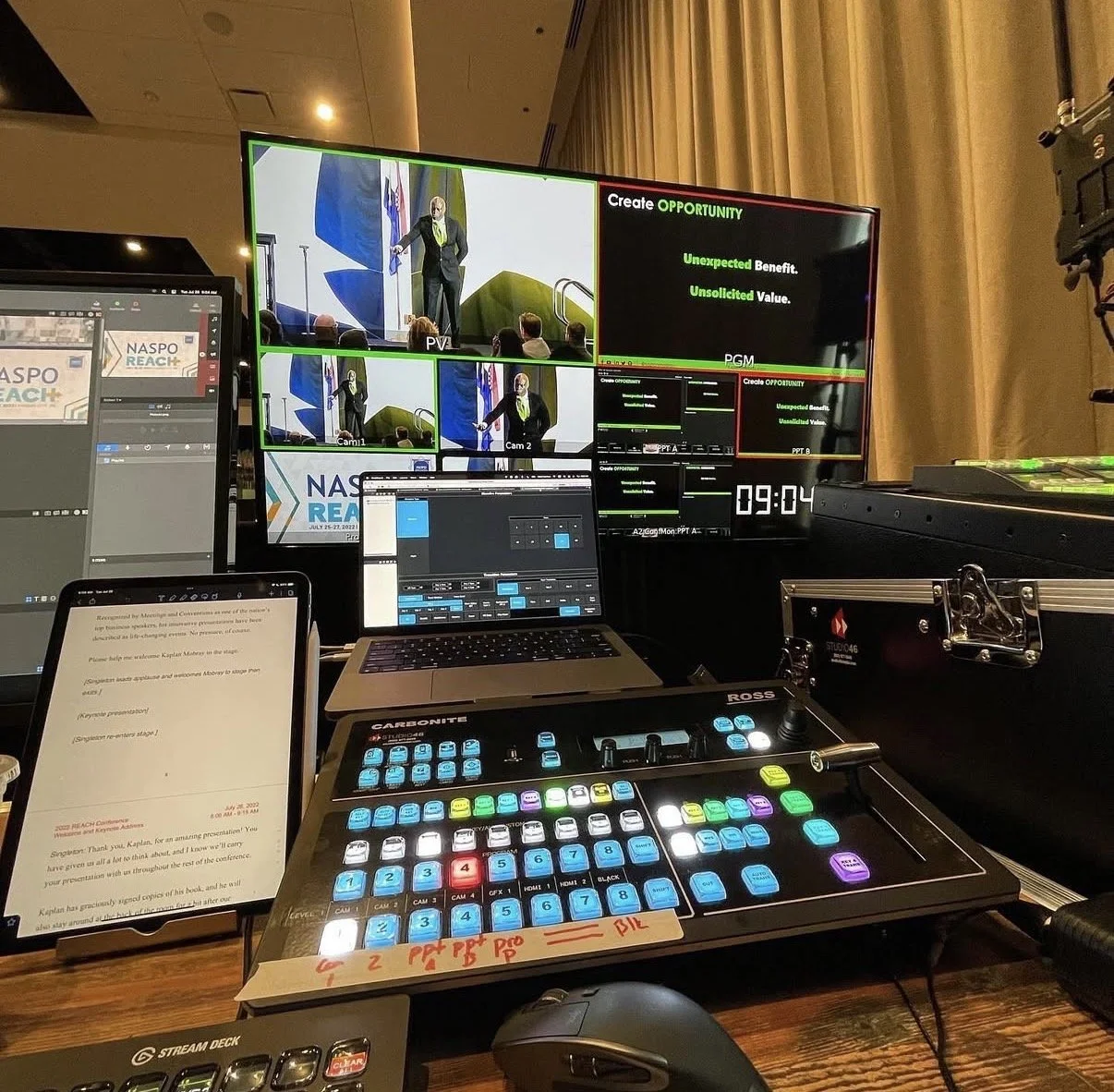 Video switcher in front of a computer monitor showing video feeds