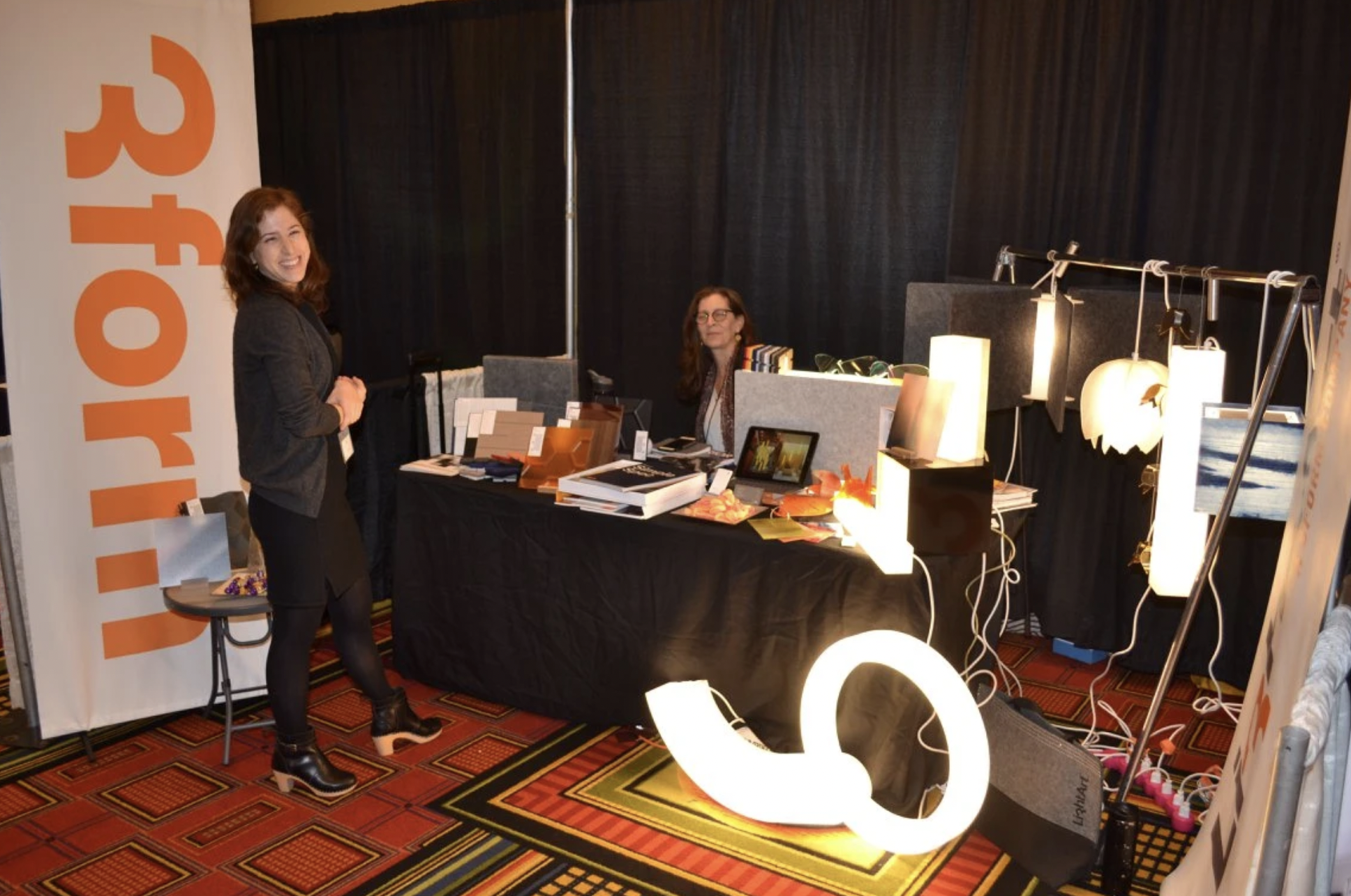  Two people posing at booth at the AIA Annual Product Fair 