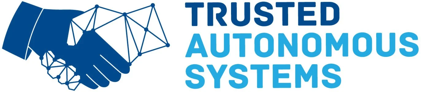 Logo showing a handshake between a human hand and a geometric, digital hand next to the text "Trusted Autonomous Systems."