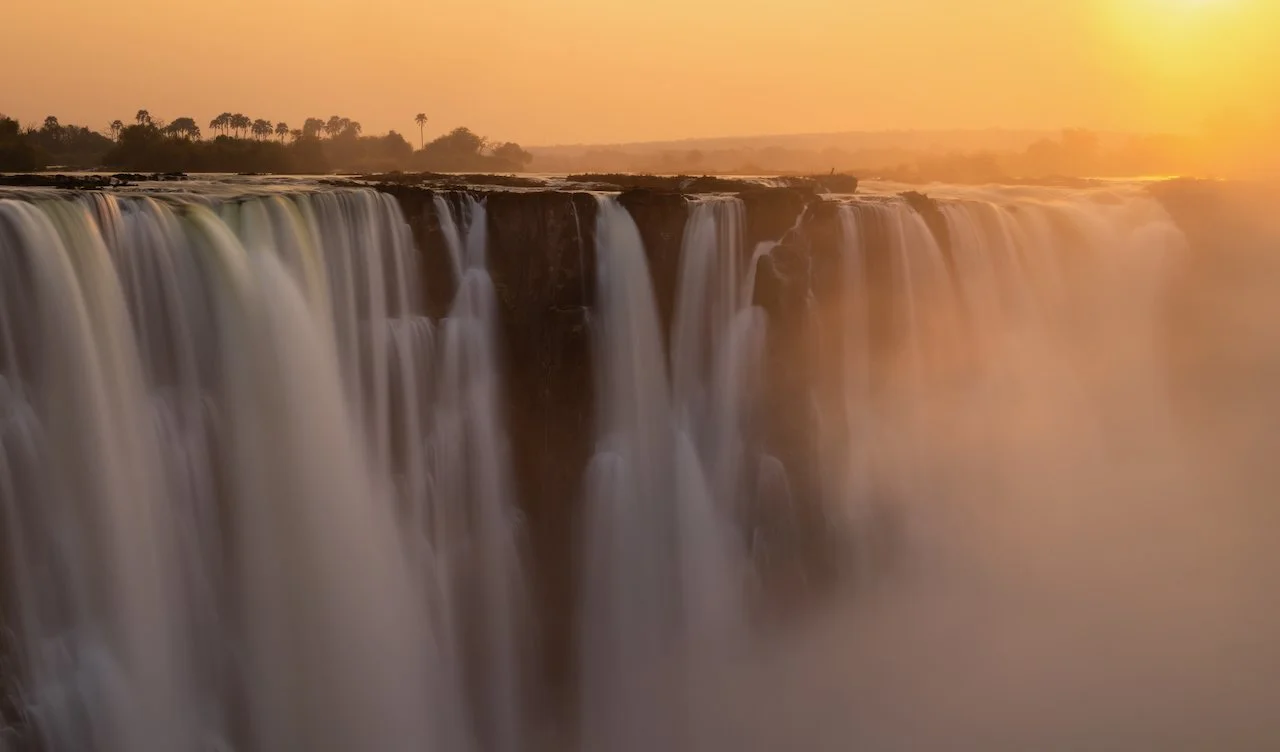 Wide view of Victoria Falls at sunrise in Zimbabwe