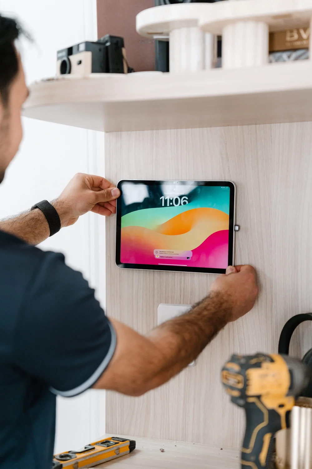 Wall-mounted iPad being installed as a smart home control panel