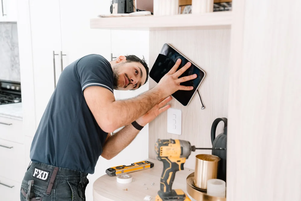 Cync electrician installing a smart home touch screen