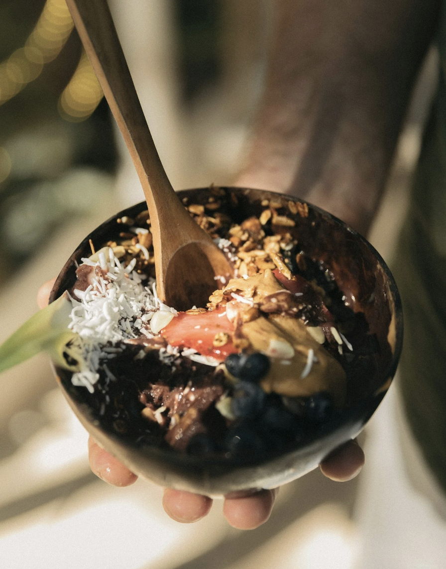 hand holding fresh acai bowl