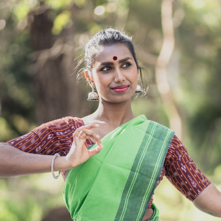 indian woman in traditional outfit dancing