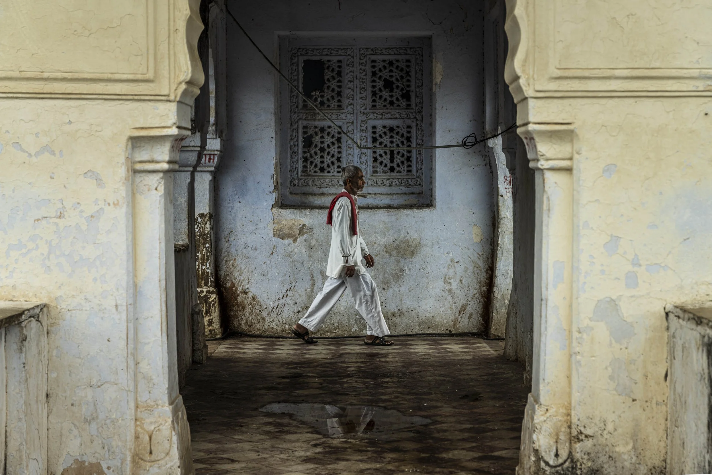 Man walking through old archway in Pushkar