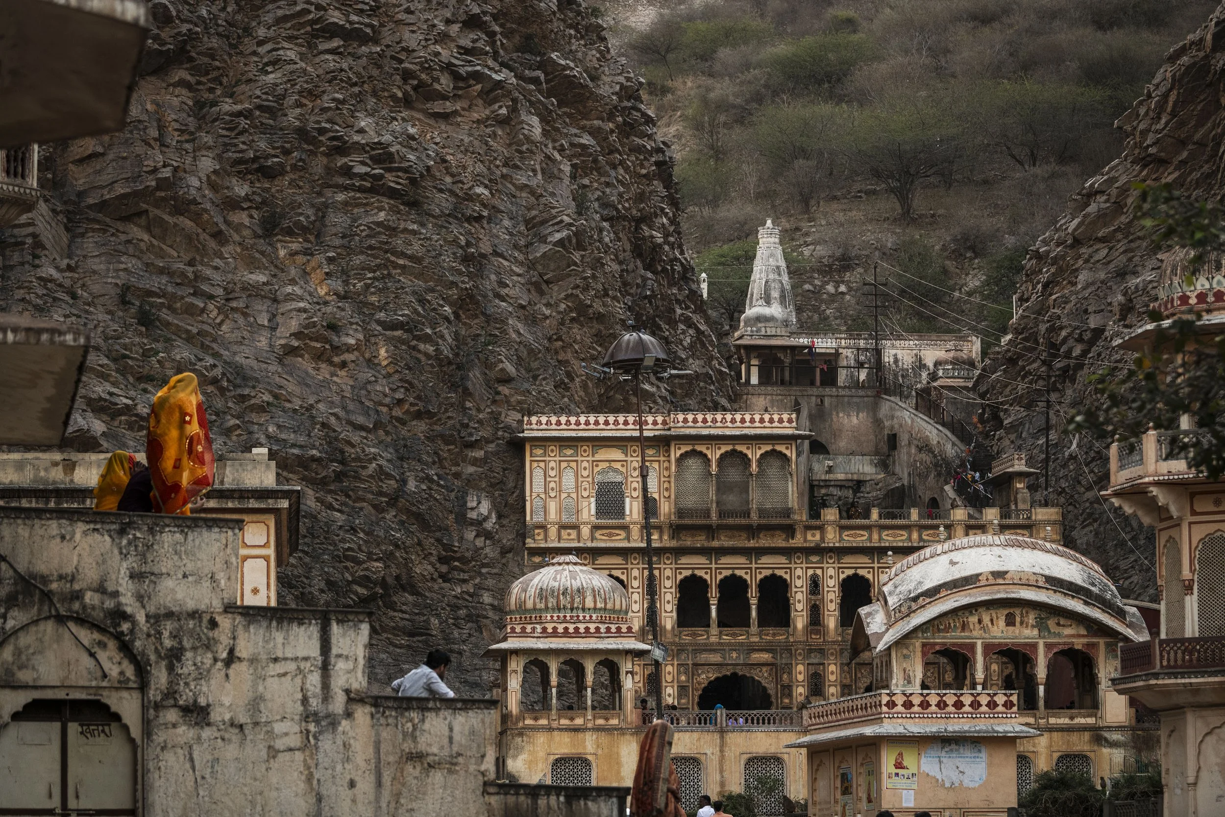Ornate facade of Galta Ji Temple framed by rocky cliffs