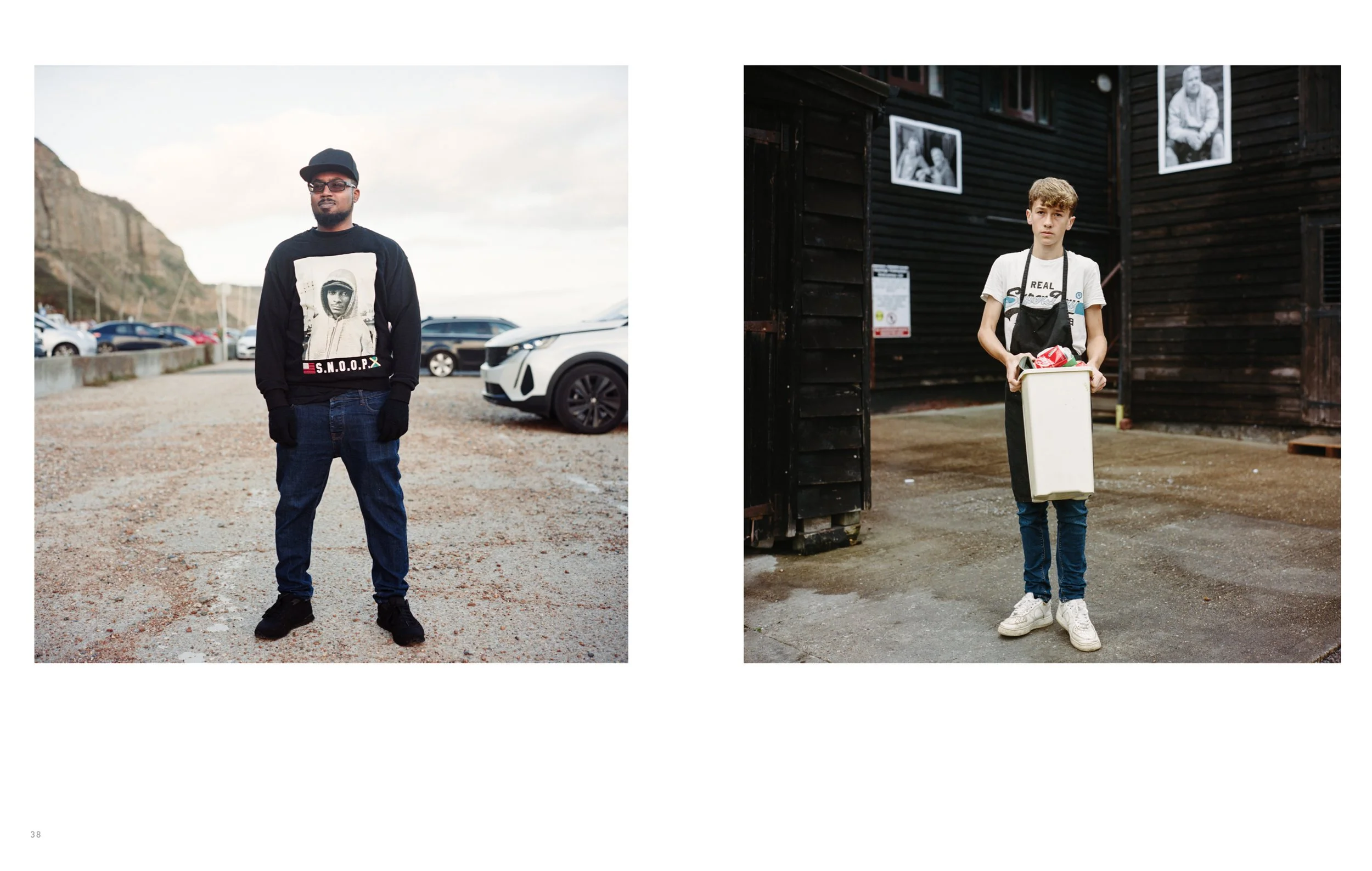 Side-by-side images of two young males standing outdoors. The left person is in a parking lot with cars, wearing a black sweatshirt with a graphic print, glasses, gloves, and a black hat. The right person is in front of a dark wooden building, holdin