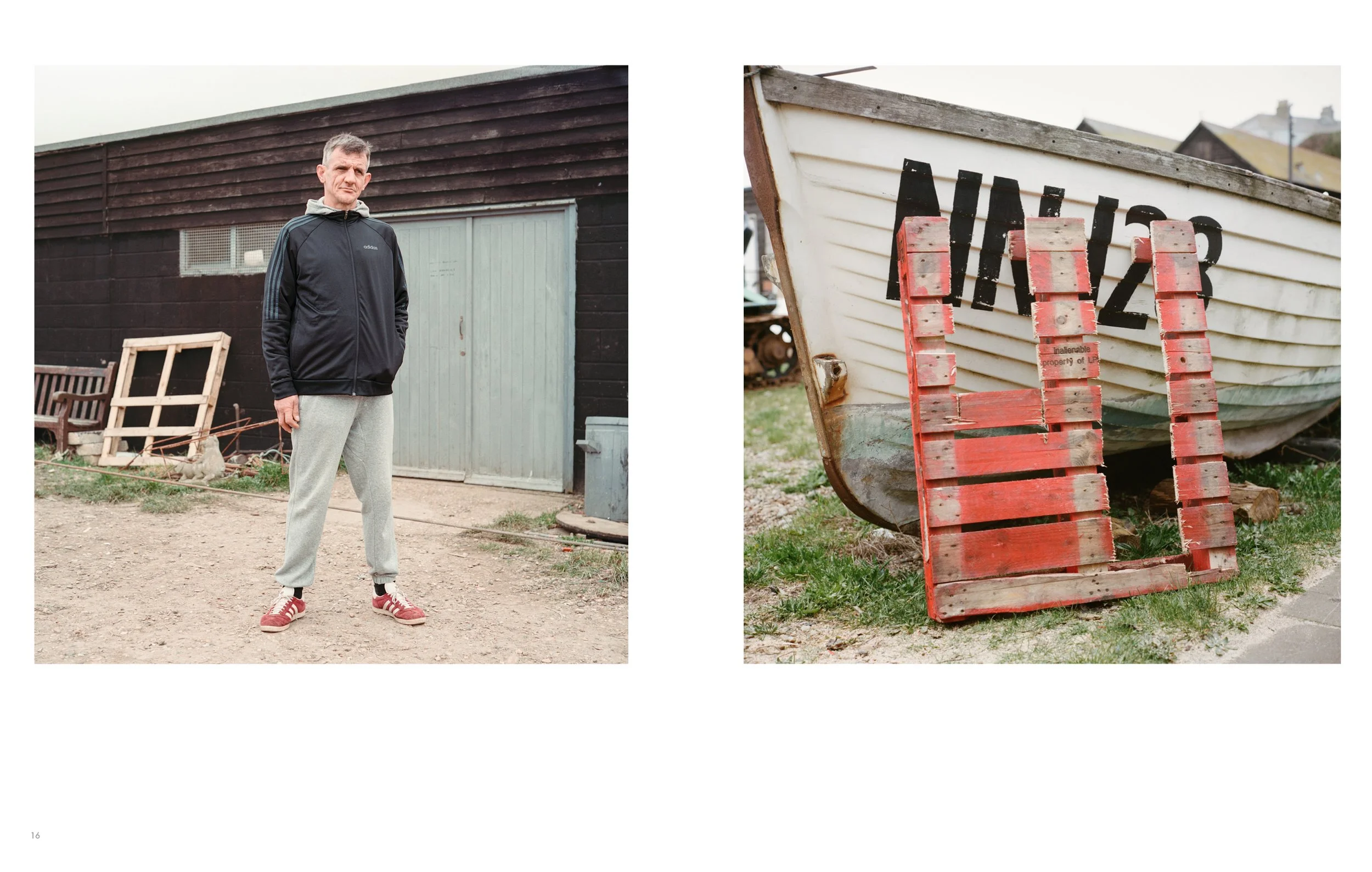 A man standing outdoors in front of a black wooden building with a small window and a door, wearing a black Adidas jacket, light gray sweatpants, and red sneakers, with a picnic bench and some wooden frames nearby. A close-up of a boat supported by a