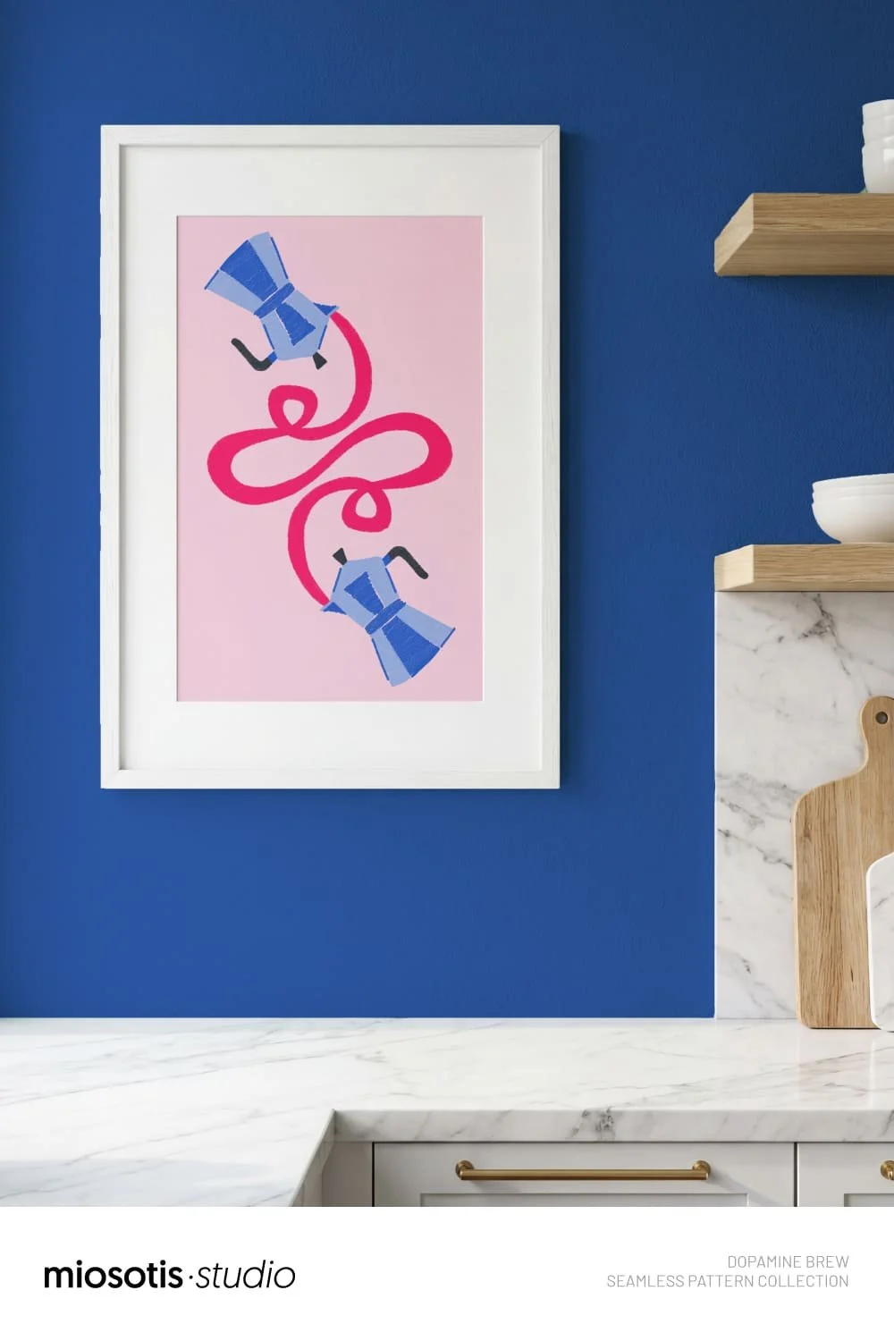 Framed coffee-themed art print with pink squiggle motif, styled in a modern blue kitchen interior.