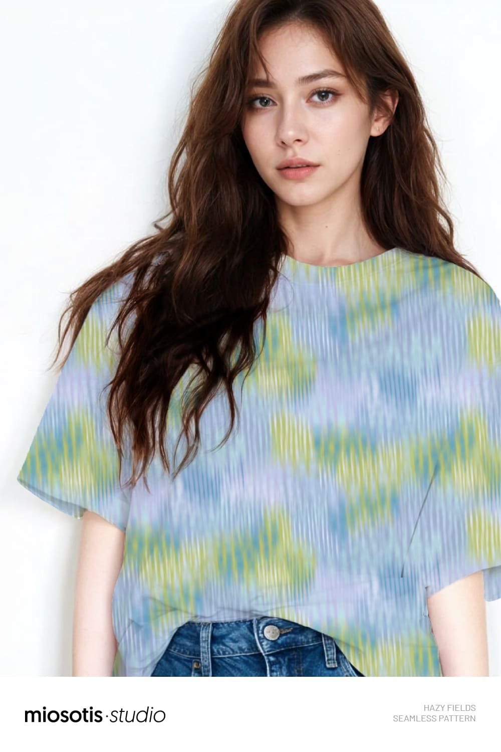 Woman wearing a T-shirt featuring the Hazy Fields abstract seamless pattern in soft green, blue and lilac tones.