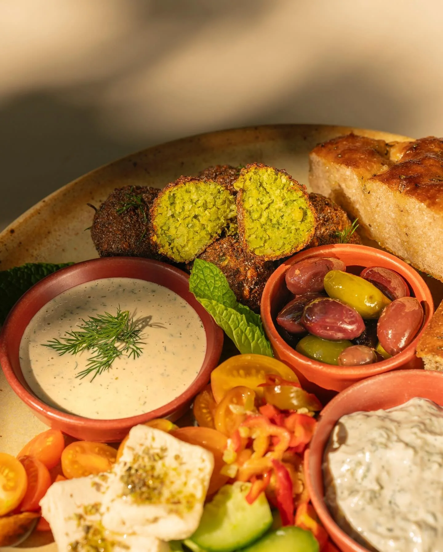 Meet your new favorite: the Swiss Chard Falafel Platter. 🌿 Crispy, golden falafel piled high with tzatziki, dill &amp; tahini, house-made vegan feta, olives, pickled peppers, and warm, pillowy focaccia. Brunch or Dinner, it&rsquo;s a must.

📷 @emma