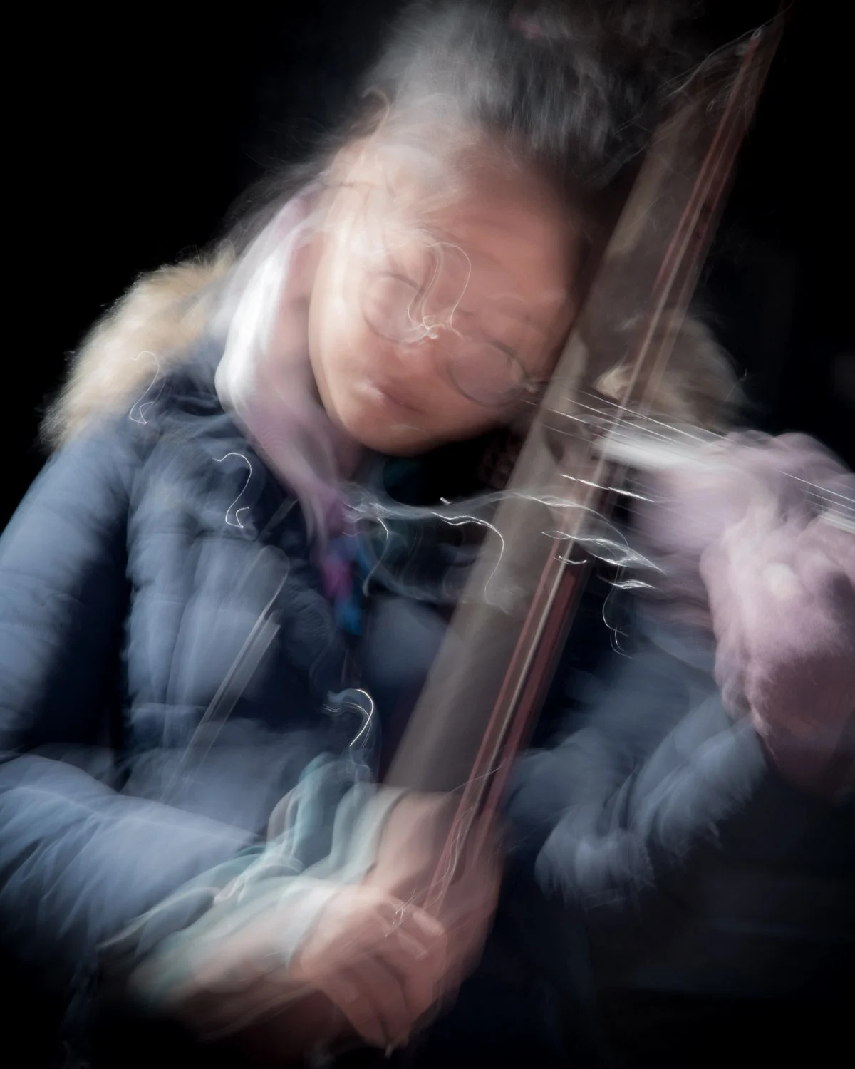  Detail is not needed in this image as the suggestion of a violin and evident emotion carry the story of the image. 