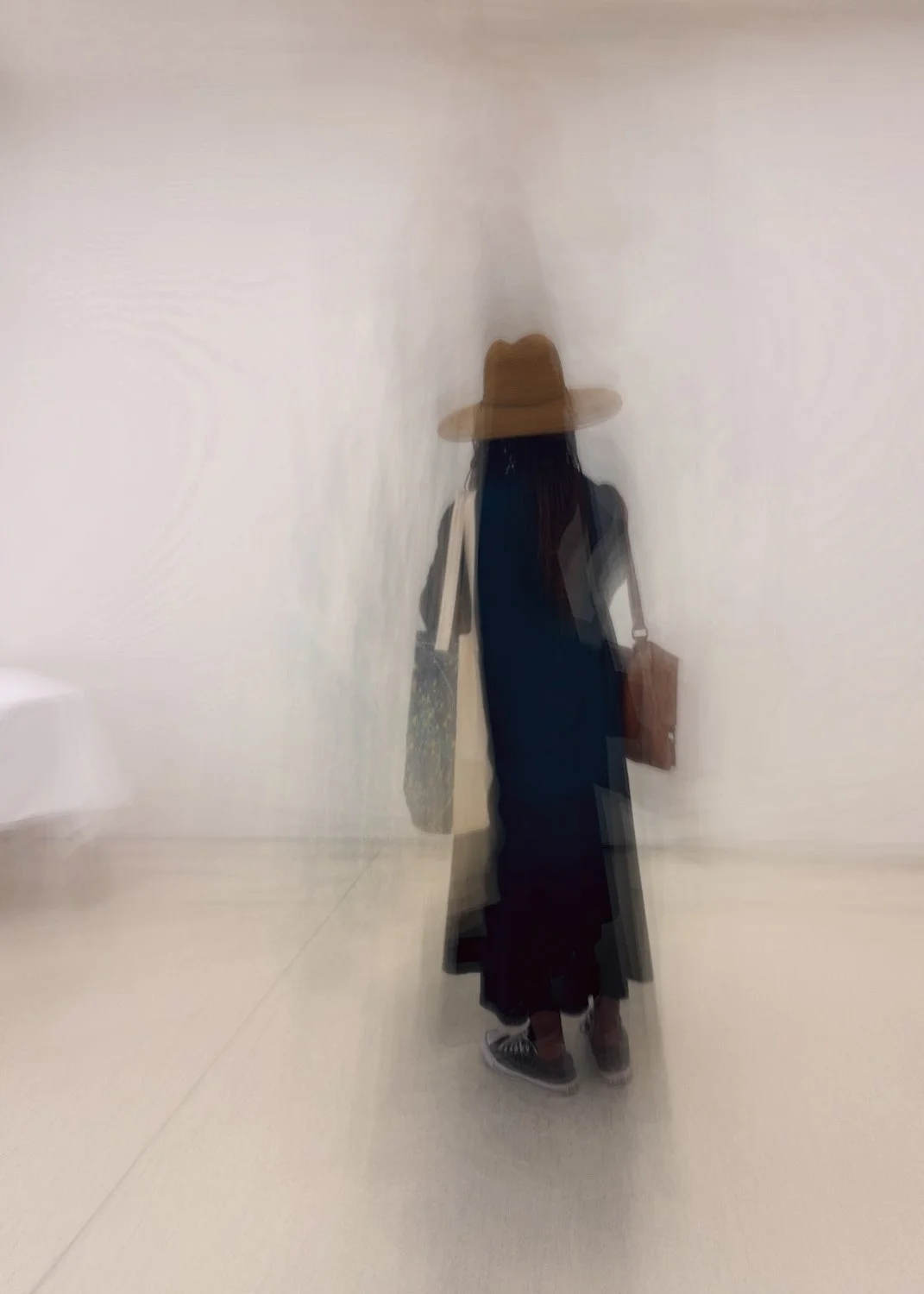 Lady in long dark coat and hat