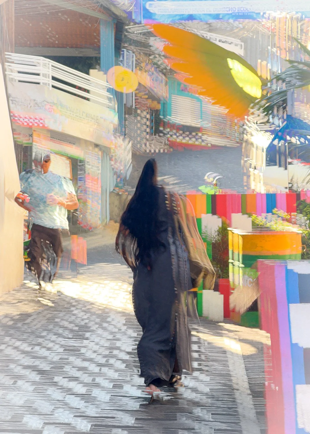 Abstract ICM Bluristic  photo - A woman walking on a cobblestone street with colorful buildings and signs in the background, along with a man in the distance wearing a white shirt and black pants.