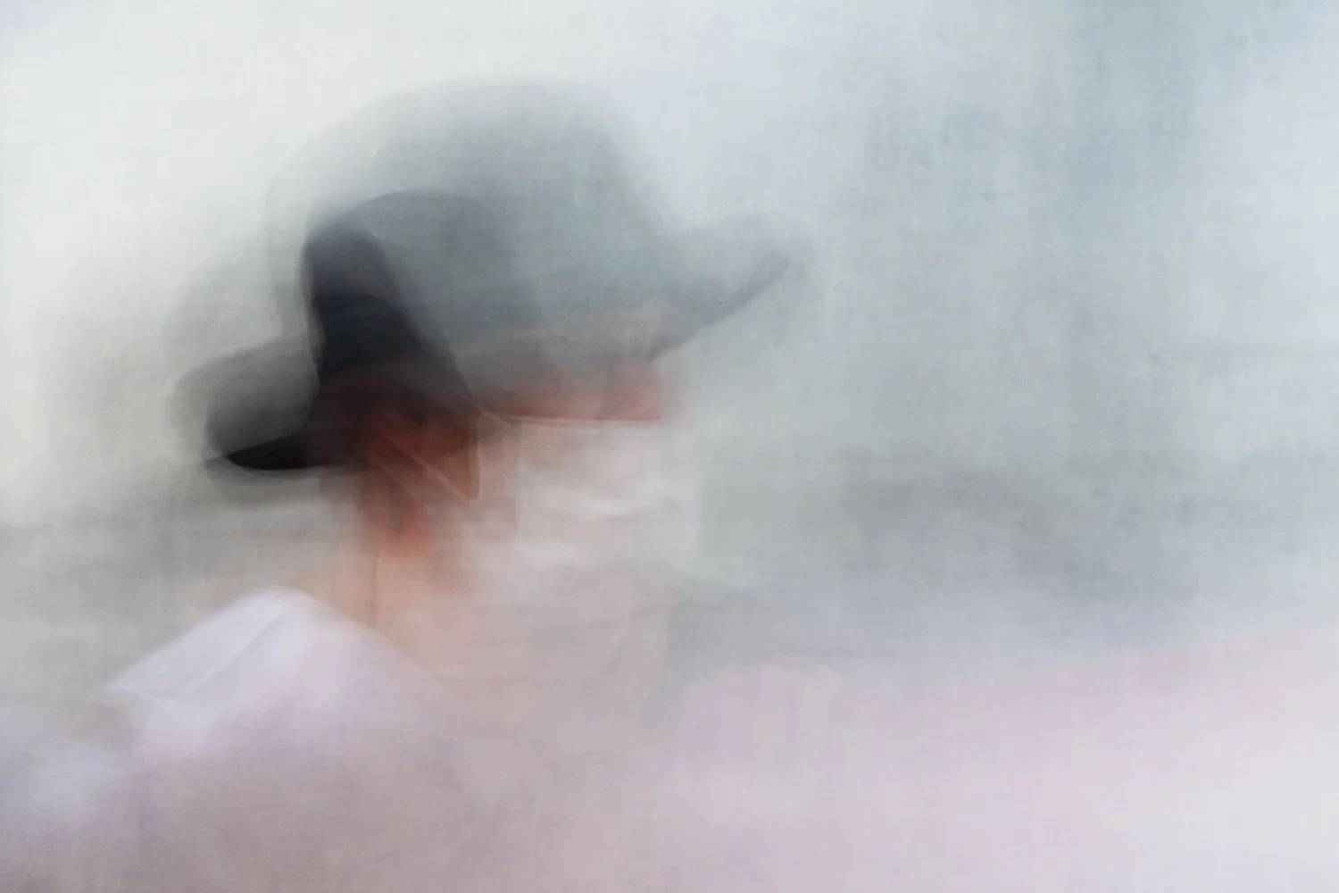 An abstract portrait of a lady wearing a large hat, her face masked during the COVID outbreak