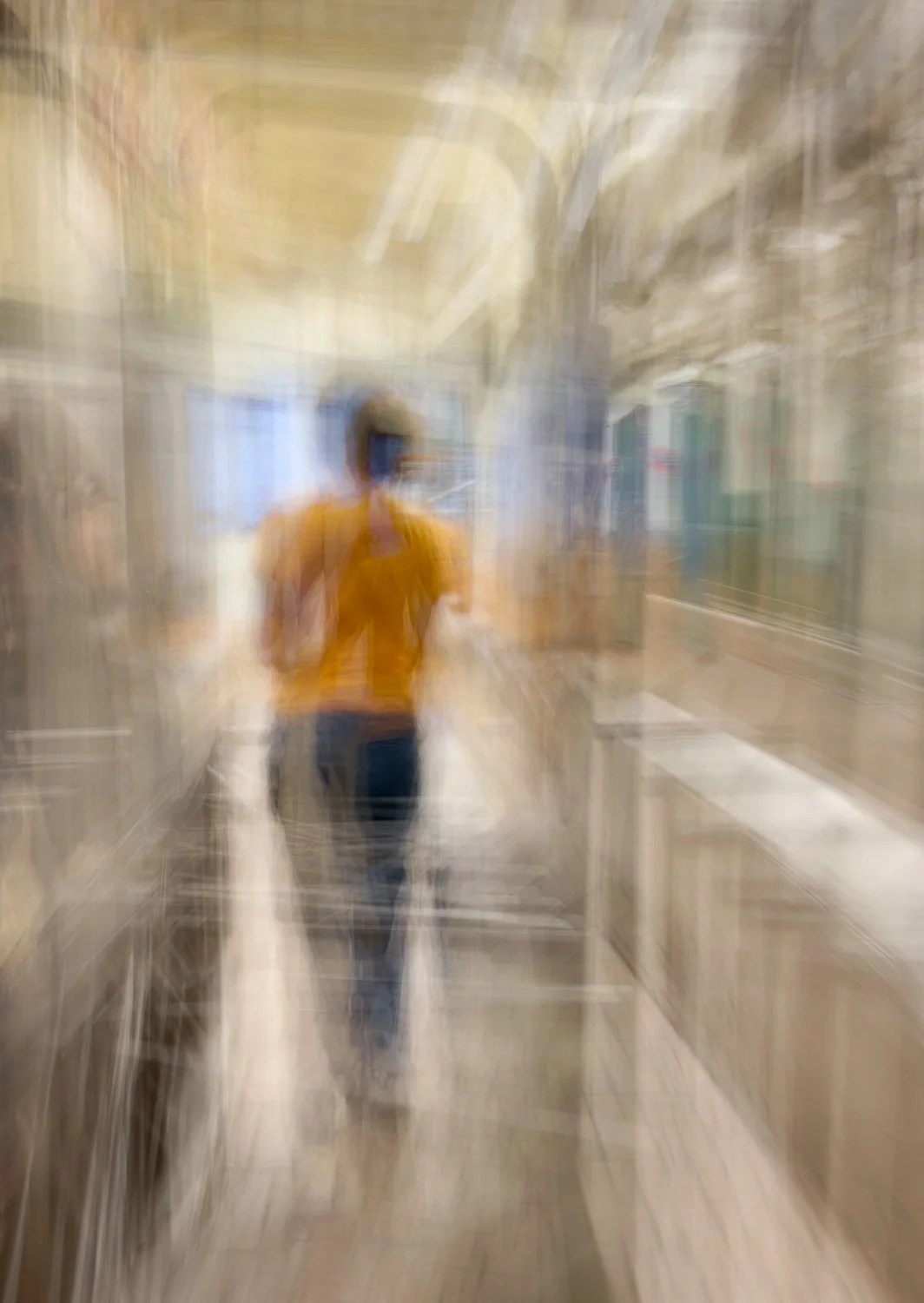 Girl in yellow sweater exiting subway turnstile