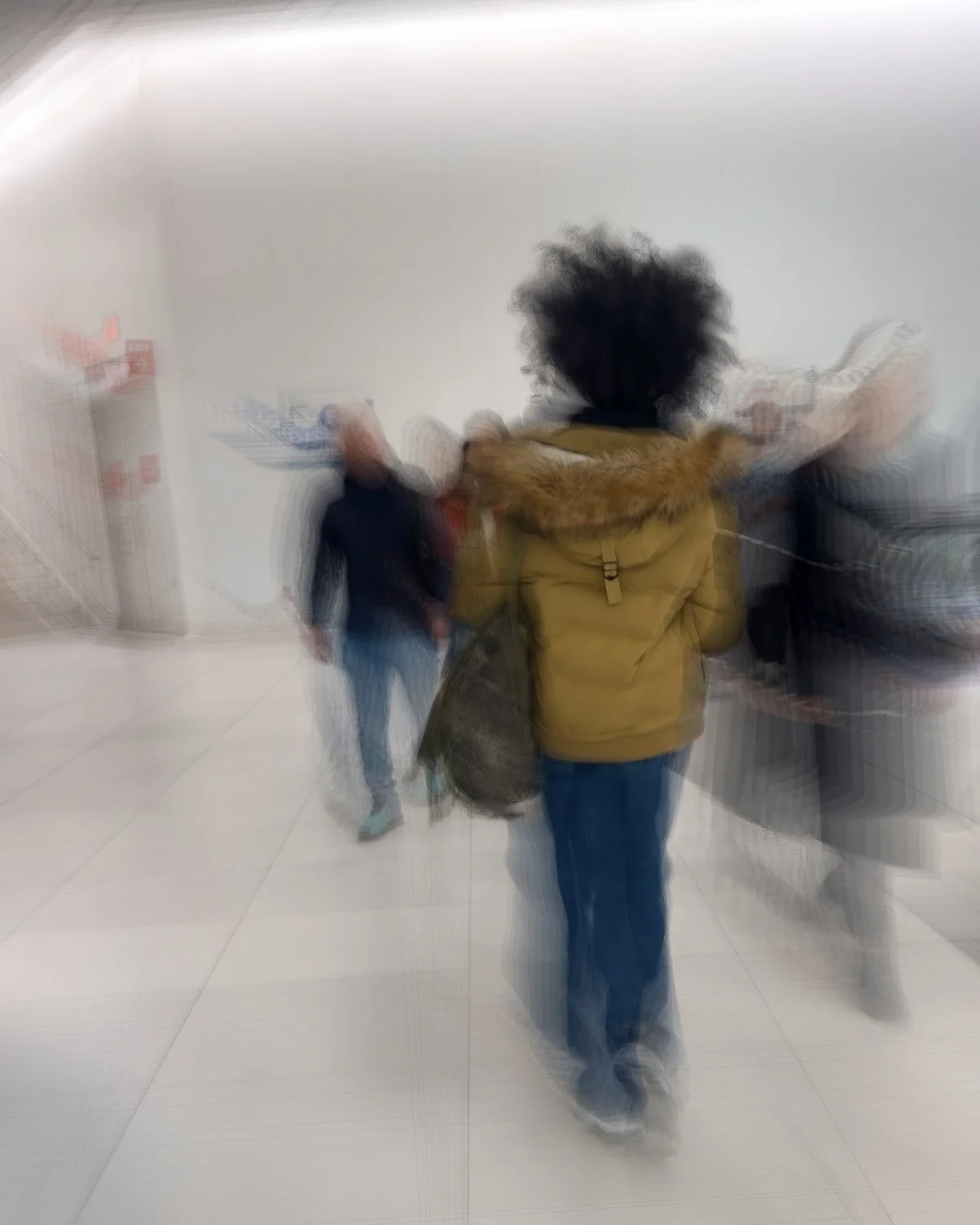 Abstract ICM Bluristic  photo - Blurred image of people walking in an indoor setting, possibly a store or a public space.