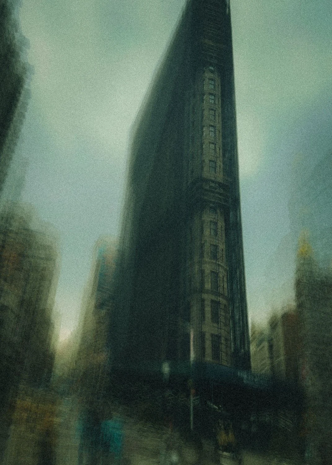 Abstract ICM Bluristic  photo - Flatiron building in a fog-like cityscape, with surrounding buildings partially visible 