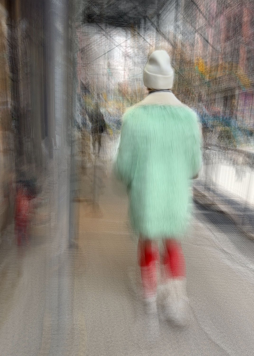 Abstract ICM Bluristic  photo - Person walking in a blurred city street wearing a white hat, mint green coat, red boots, and white pants, with buildings and signage in the background.