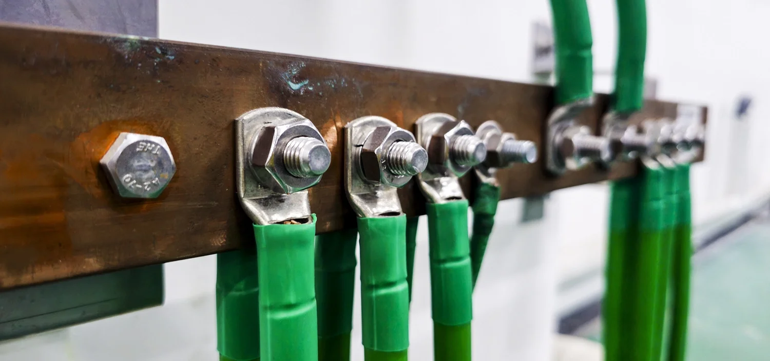 lose-up of green insulated and bare copper ground wires illustrating electrical grounding and bonding