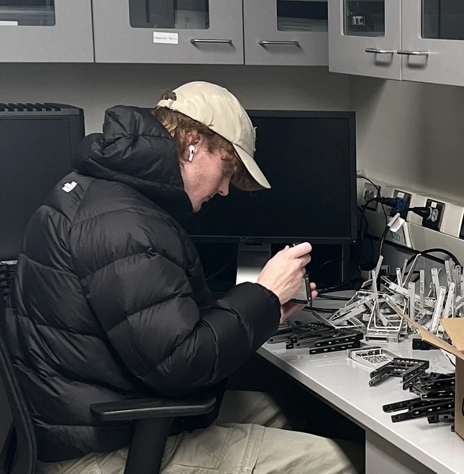 Technician working on server hardware at a workbench in a Computing for Humanity data centre.