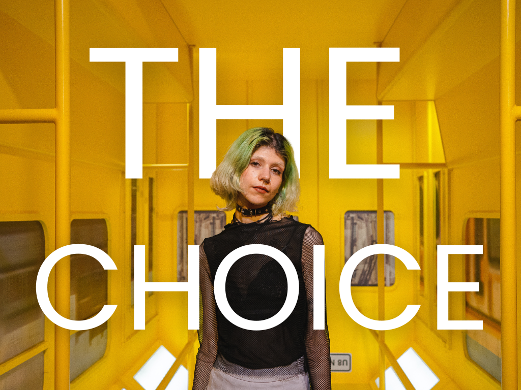 An image from London Portrait Photographer Donnell Asare's blog shows a person with light green hair standing in a vivid yellow corridor, wearing a black mesh top and choker necklace. Bold white text reading “THE CHOICE” overlays the scene