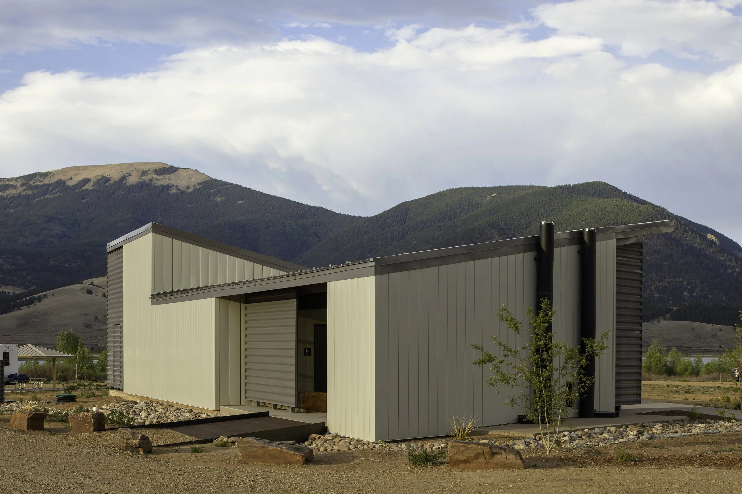 Comfort Station with roofline mimicking the slope of the mountains beyond