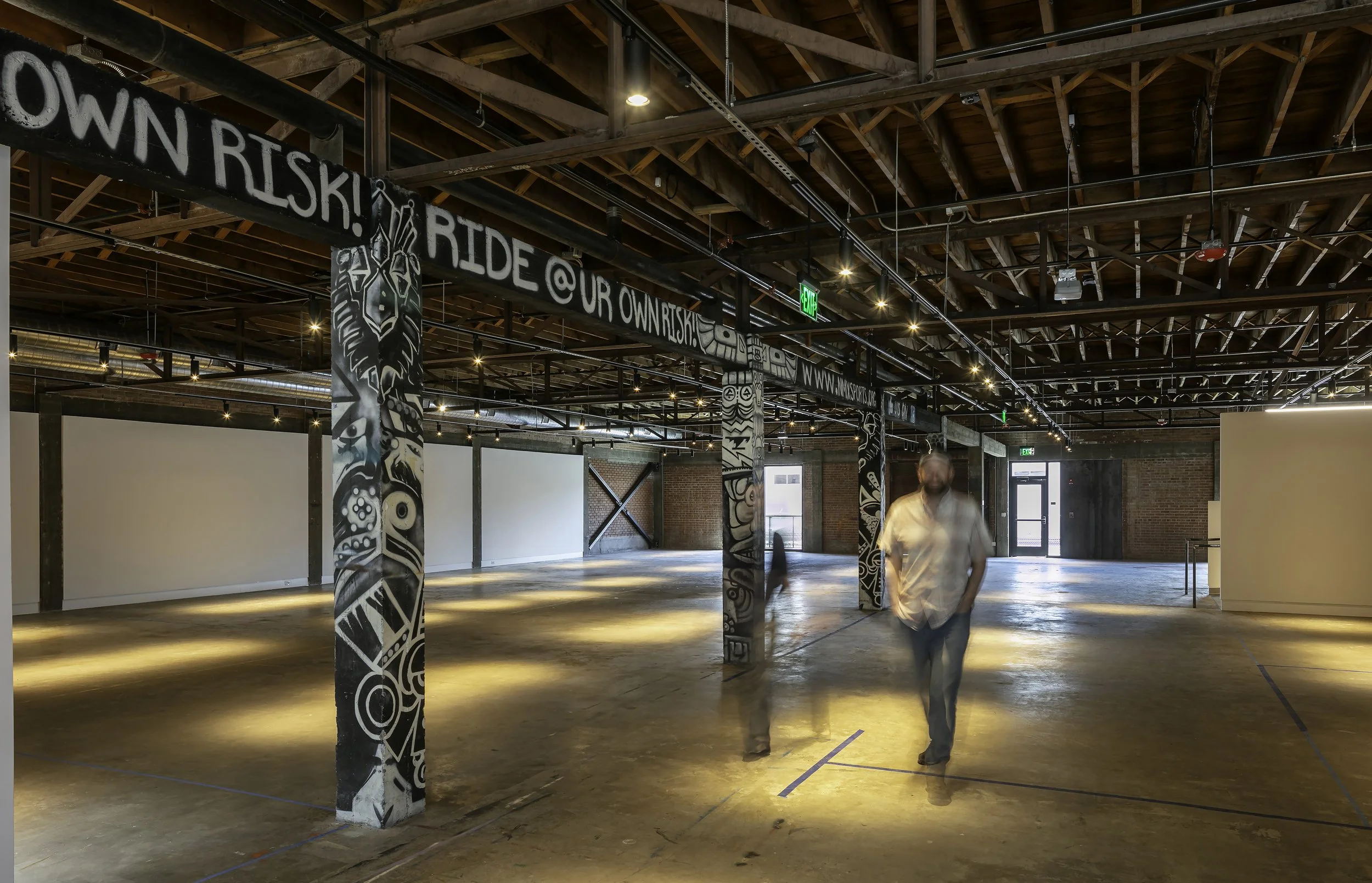 Renovated main gallery space with a visitor walking through