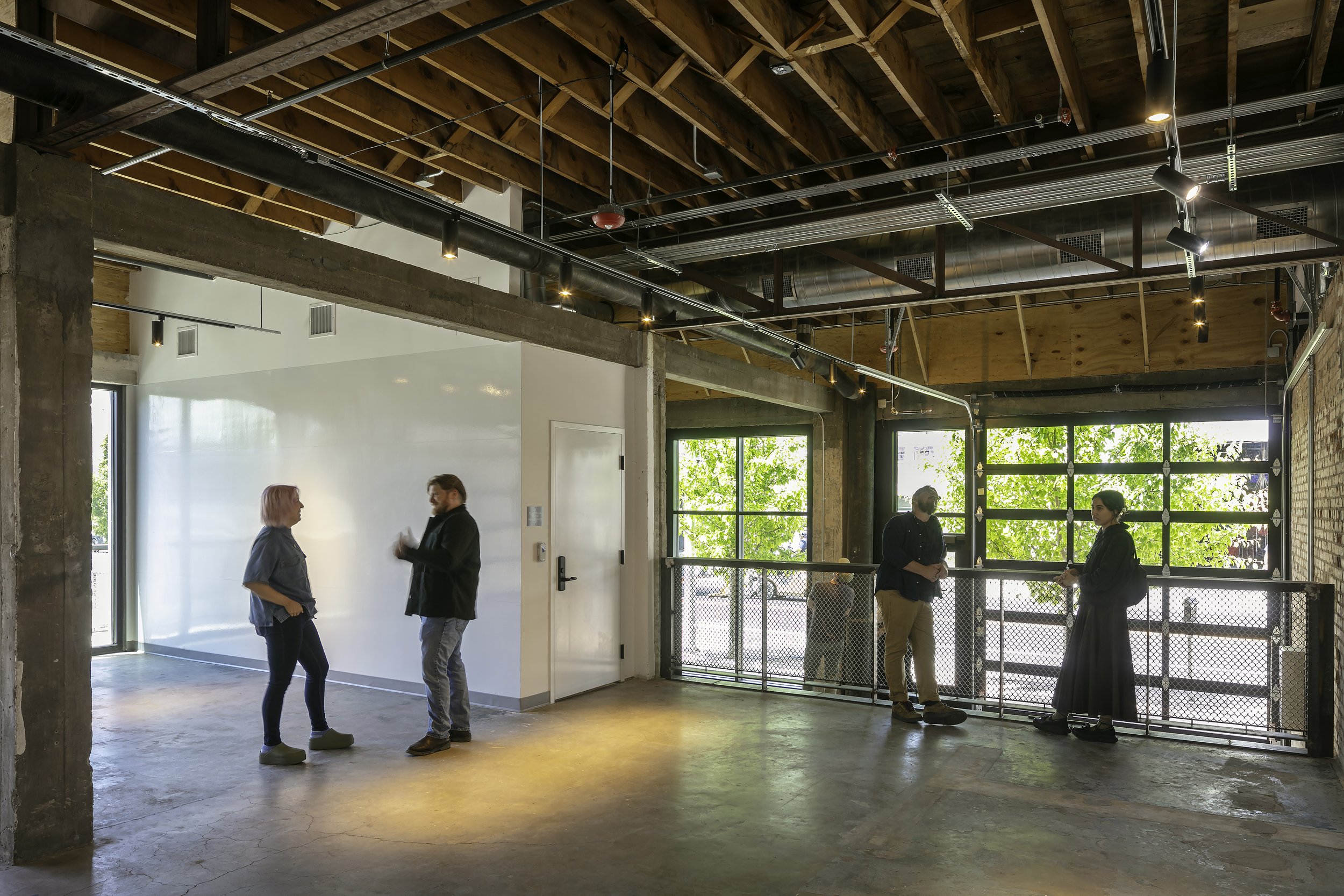 Visitors spending time in gift shop area surrounded by glass overhead doors and natural light