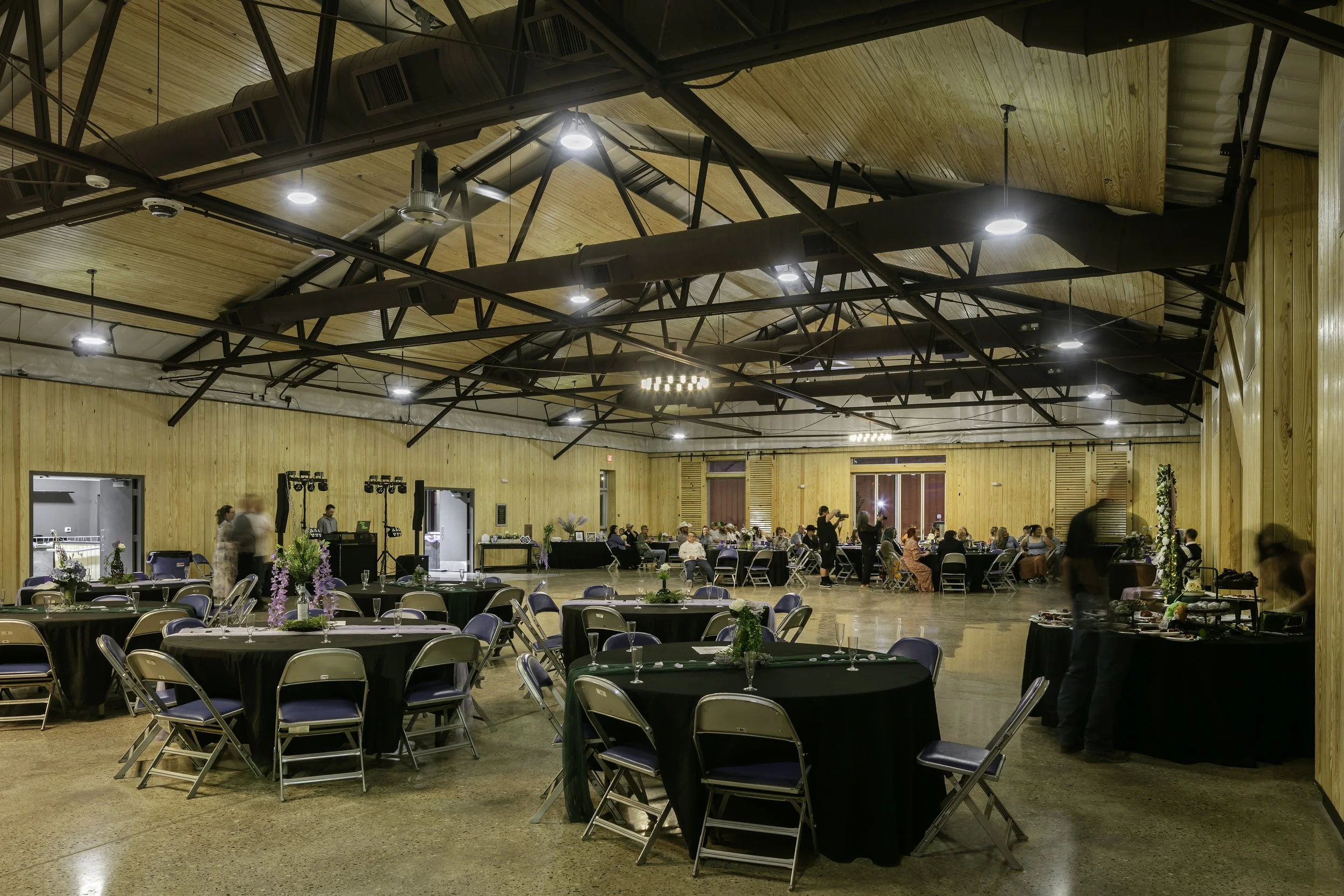Renovated modern events space filled with wedding decorations and guests