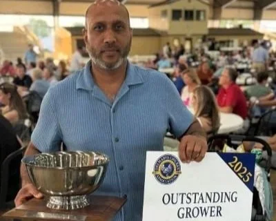 Mohammad Sheikh holds outstanding grower awards