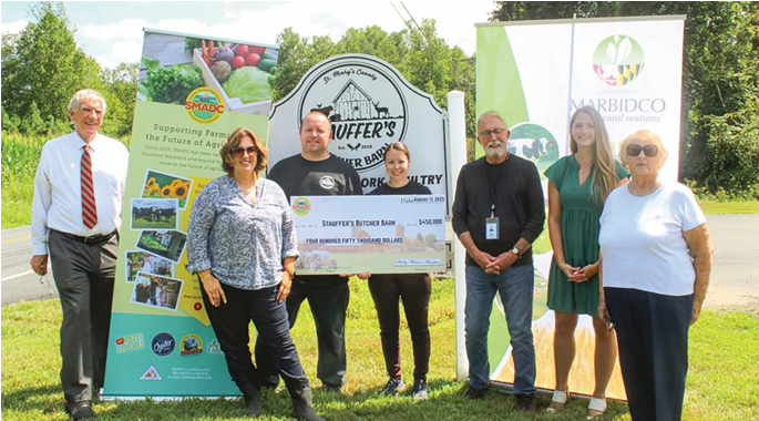 Steven and Jen Stauffer stand with SMADC and MARBIDCO representatives