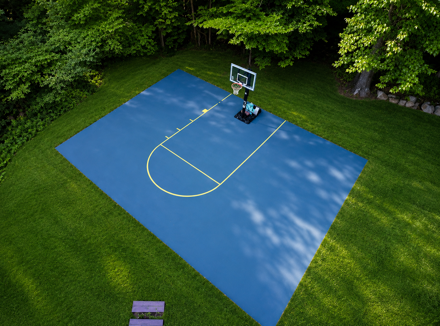 Outdoor basketball court and recreational space at the Limitless Recovery Solution men's sober living home in Abington, Massachusetts.