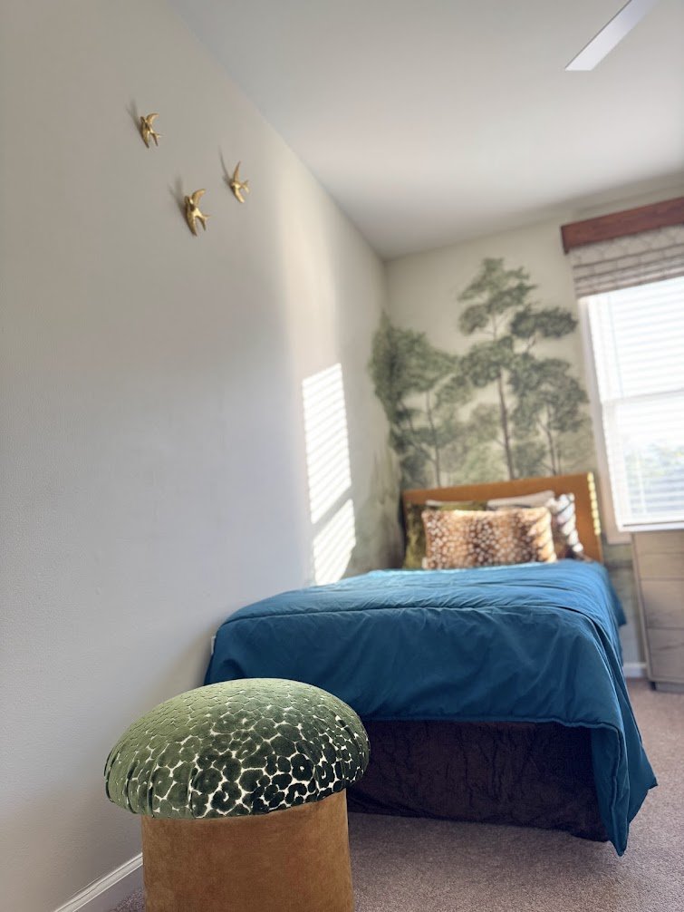 Playful nature inspired details like brass birds and a mushroom ottoman bring the forest theme to life.