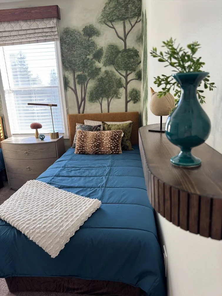 Curated details in teal, brass, and natural wood add warmth and sophistication.