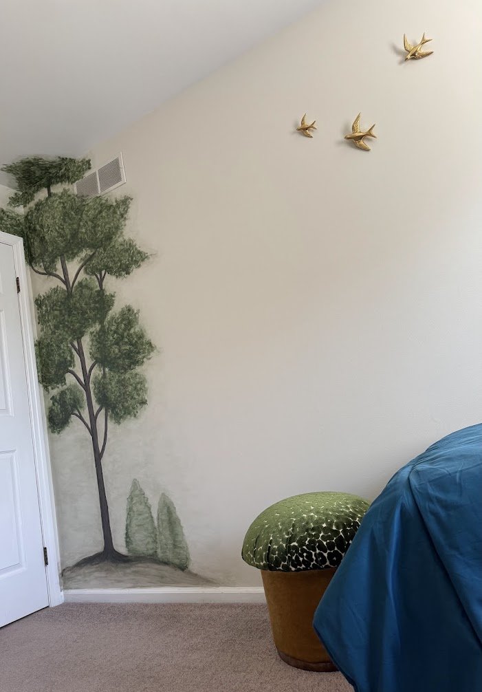 Brass birds in flight above a hand-painted tree, a subtle detail that sparks imagination.