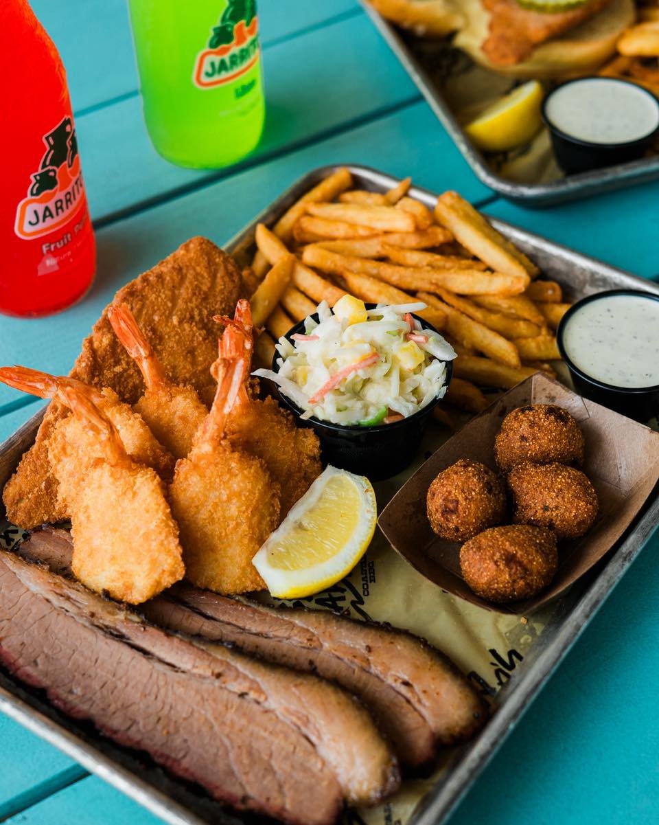 Why choose when you can have it all? 🤙🔥 Our Surf &amp; Turf Platter brings crispy flounder, shrimp, and slow-smoked brisket together on one plate. Served with fries, coastal slaw, and hush puppies. Big flavor, no regrets.