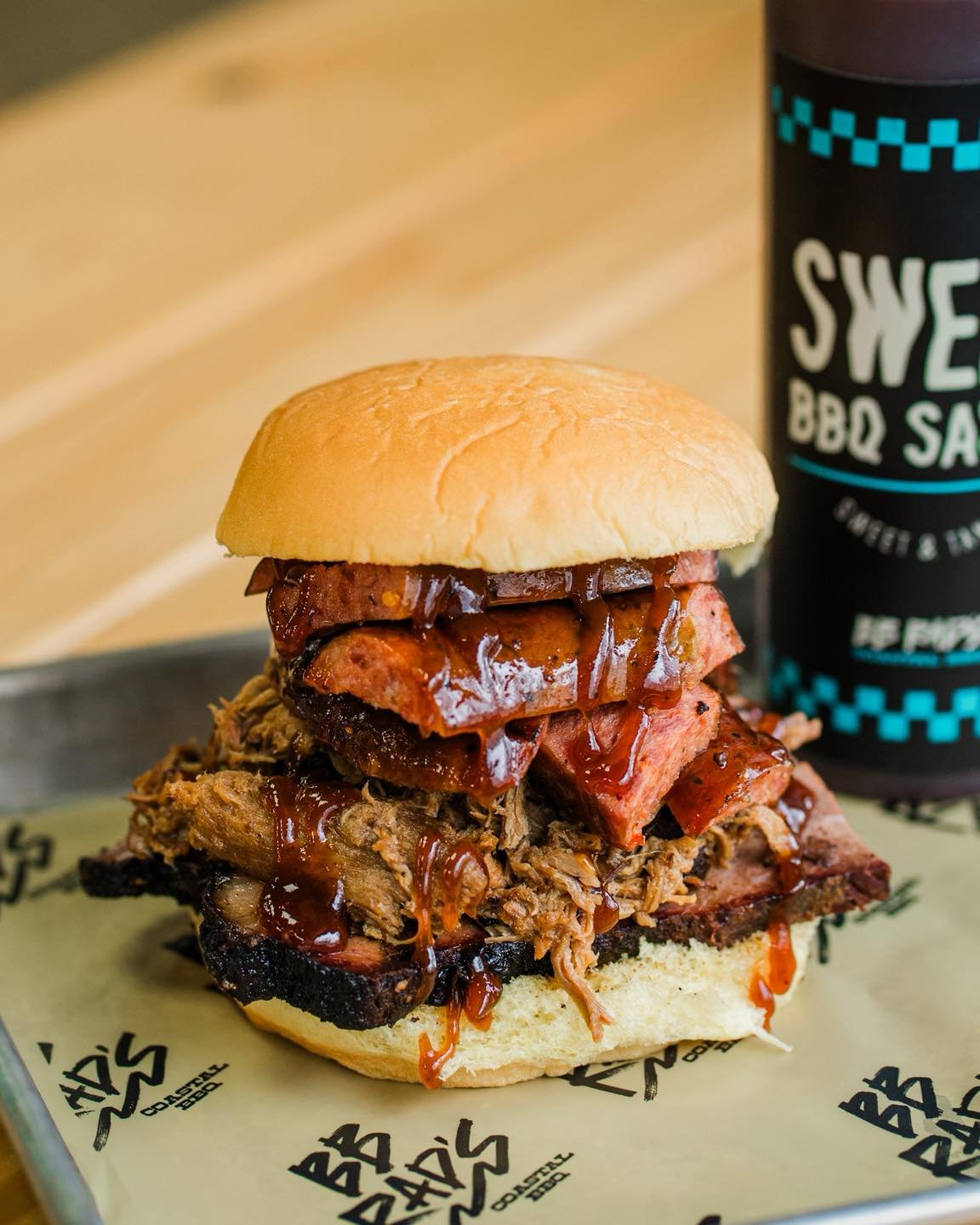 Meet The Beast 🤙🔥

A triple-threat sandwich stacked with a &frac14; lb of brisket, pulled pork, and sausage all piled high on a bun. Built for serious hunger and not for the faint of heart. Come see if you can handle it!