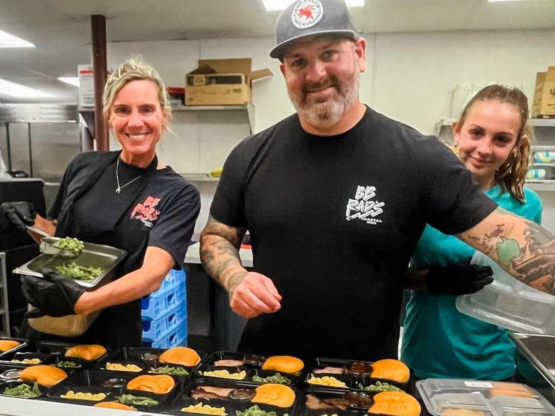 Owners preparing catering trays at BB Rad's Coastal BBQ