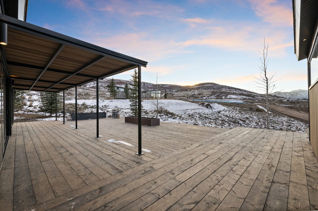 Icon-House-Benloch-Heber-City-Exterior-Covered-Deck-Wood-Planks-Sunset-View-Snowy-Hills-Roderick-Builders-Modern-Custom.jpg