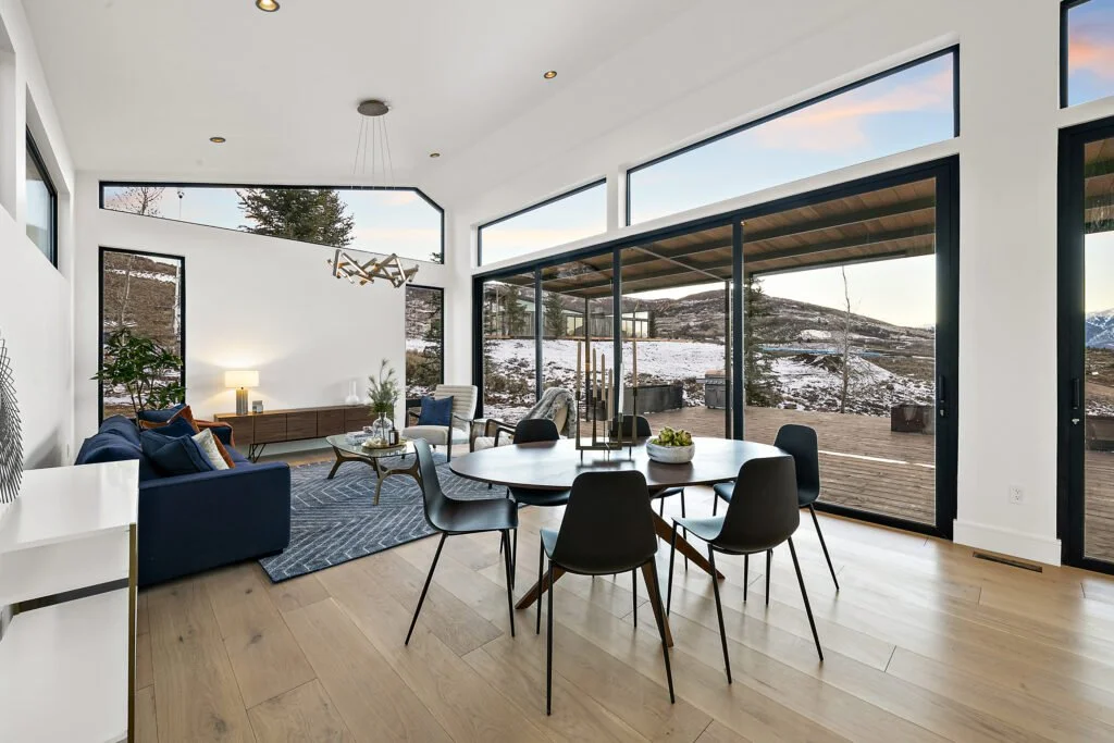 Icon-House-Benloch-Heber-City-Living-Dining-Open-Concept-Sliding-Glass-Wall-Vaulted-Ceiling-Roderick-Builders-Modern-Custom.jpg