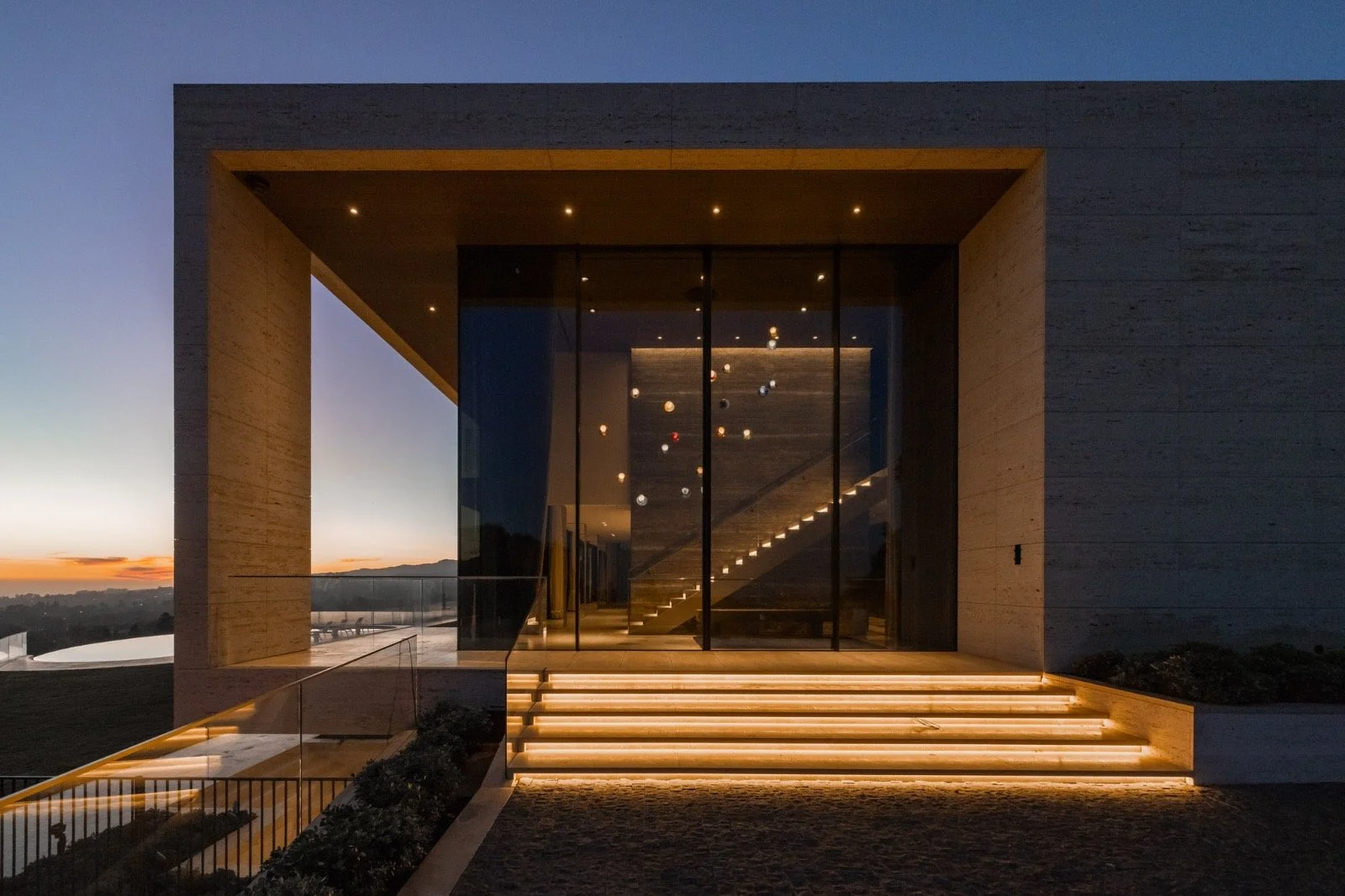 684-Firth-Brentwood-CA-LA-Exterior-Travertine-Entry-Dusk-Glass-Facade-Illuminated-Steps-Roderick-Builders-Modern-Home.JPG