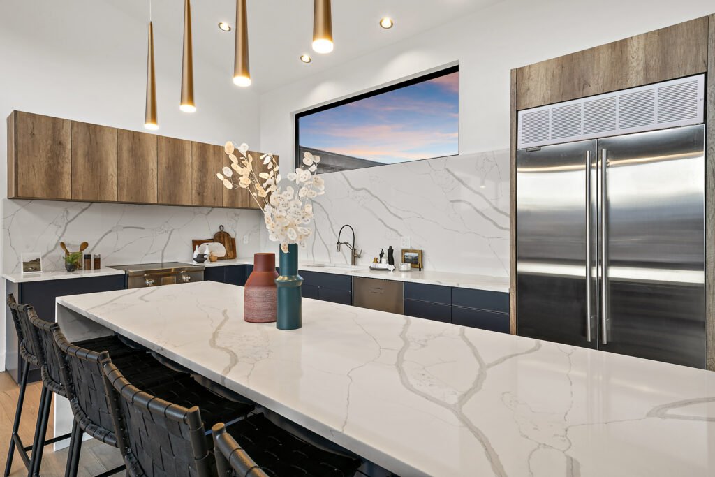 Icon-House-Benloch-Heber-City-Kitchen-Waterfall-Island-Marble-Backsplash-Stainless-Fridge-Roderick-Builders-Modern-Custom.jpg
