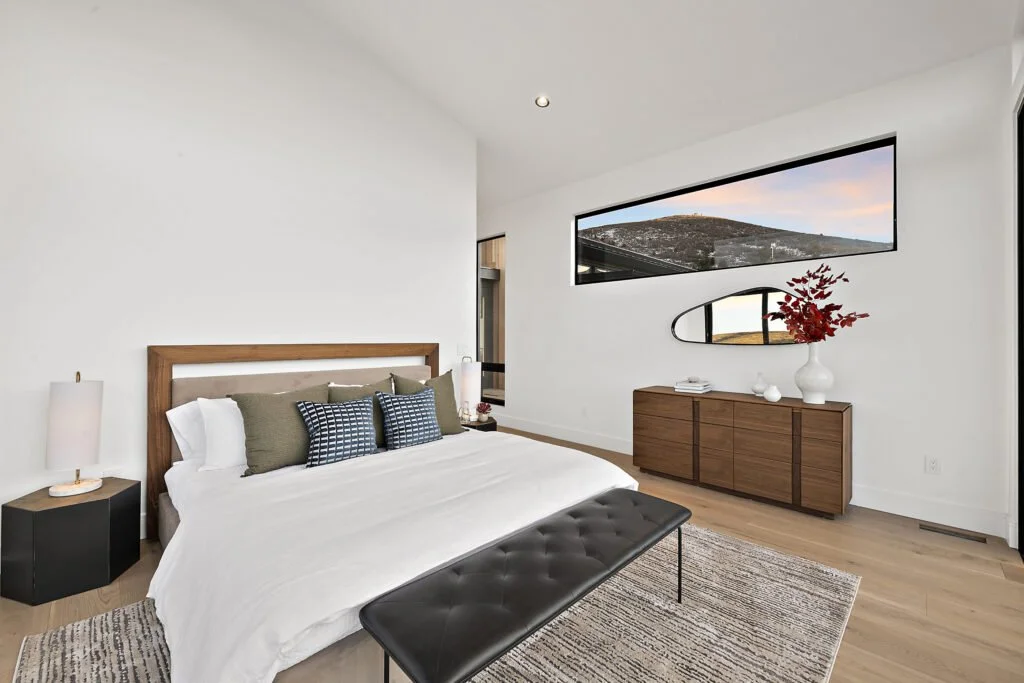 Icon-House-Benloch-Heber-City-Bedroom-Picture-Window-Wood-Dresser-Leather-Bench-Hillside-View-Roderick-Builders-Modern-Custom.jpg
